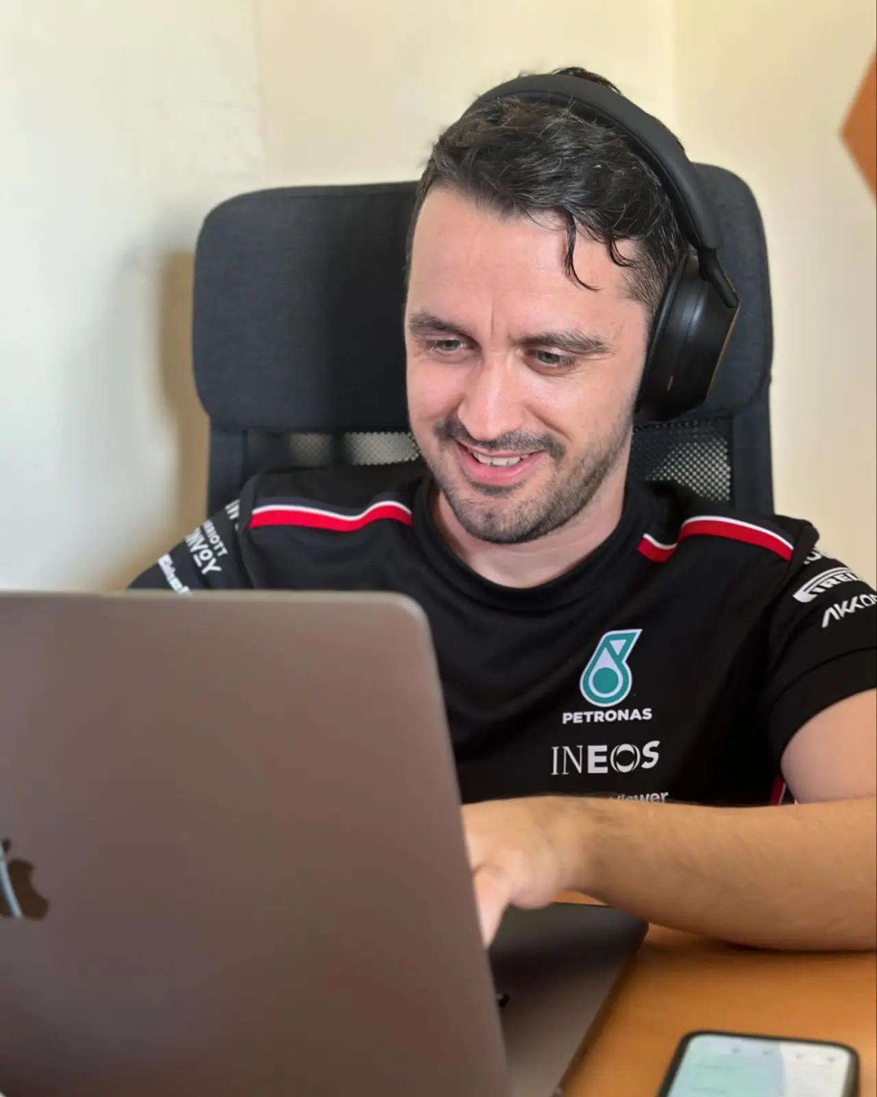 A Tribus developer in the zone, headphones on at the laptop