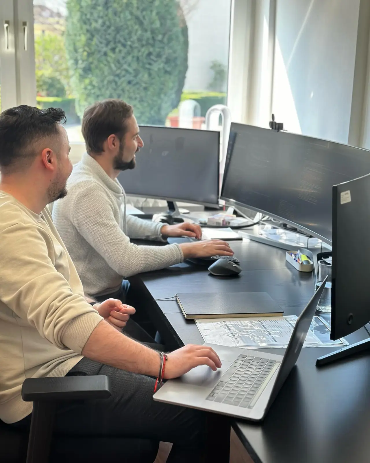 Two engineers pair-programming at the Bucharest studio